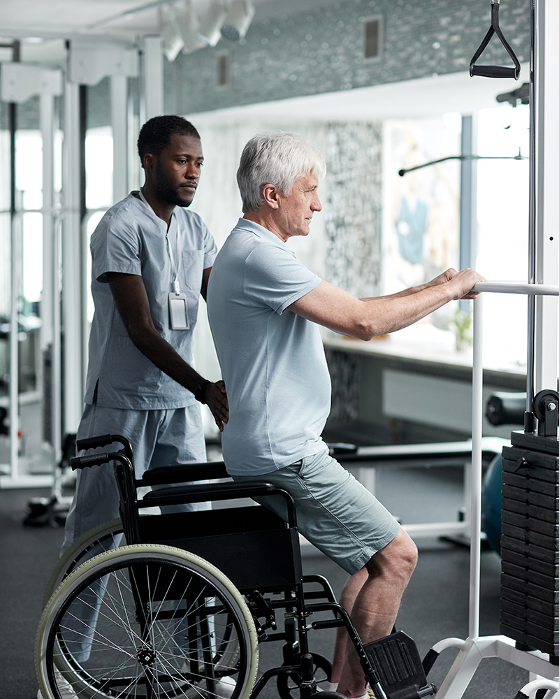 Senior Man doing Rehabilitation Exercises in Gym Ennis Nursing Facility